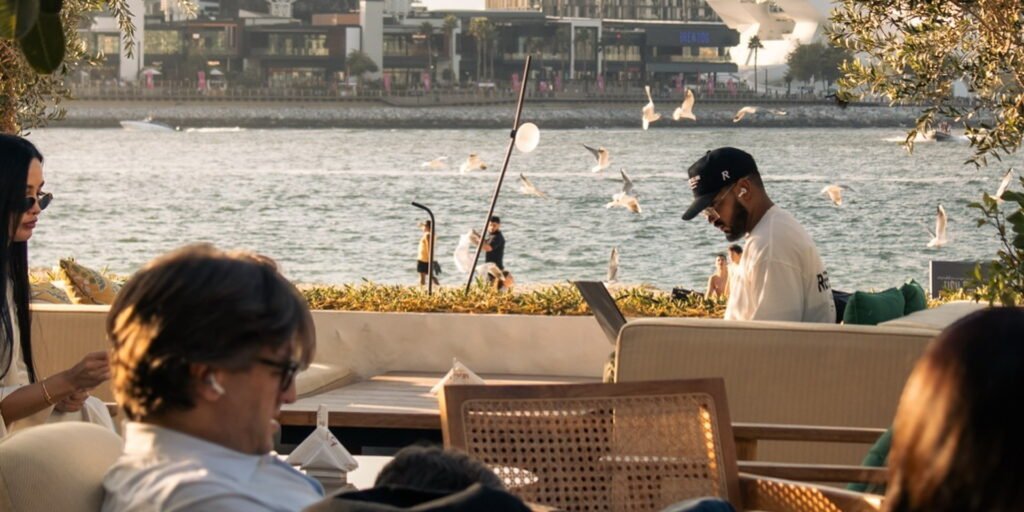 Best shisha lounge in JBR with waterfront seating, modern skyline views, and guests enjoying a relaxed social vibe.