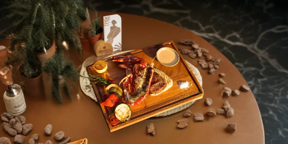 Grilled lobster platter at Mehzcla Restaurant table setup